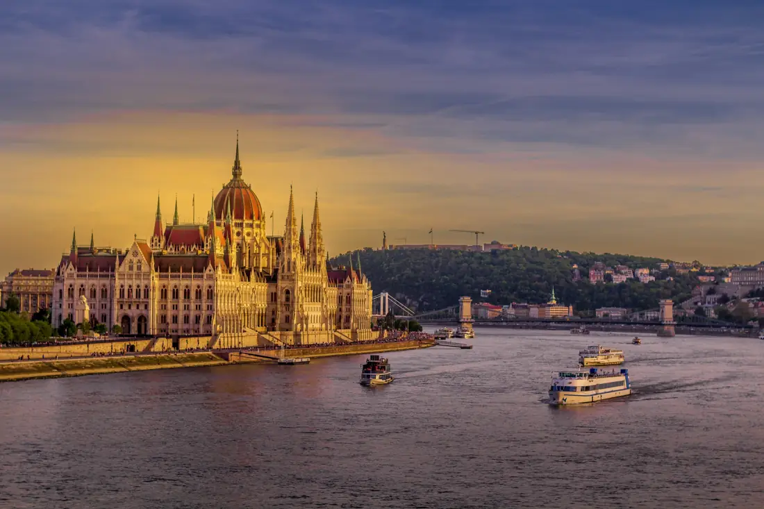 The Hungarian Parliament building on the Danube river at sunset